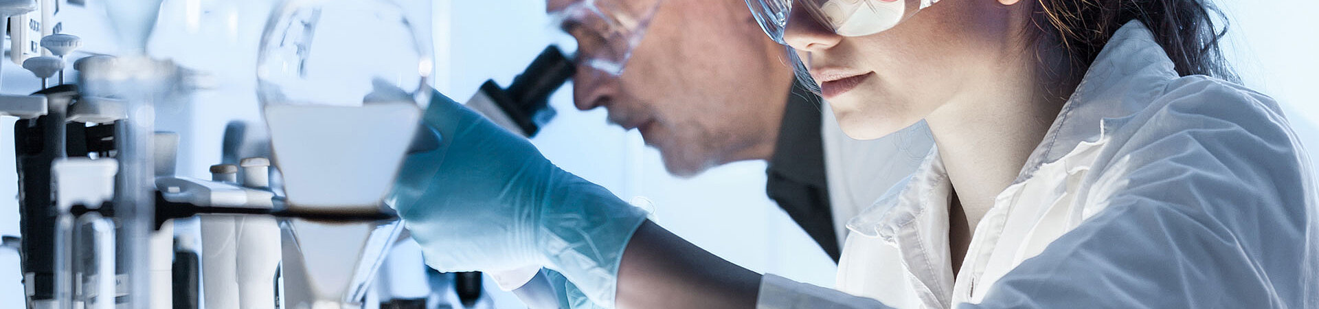 2 scientists with a microscope